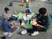 小学生と農経会ボランティアが楽しそうにお話しながらカレーを食べています